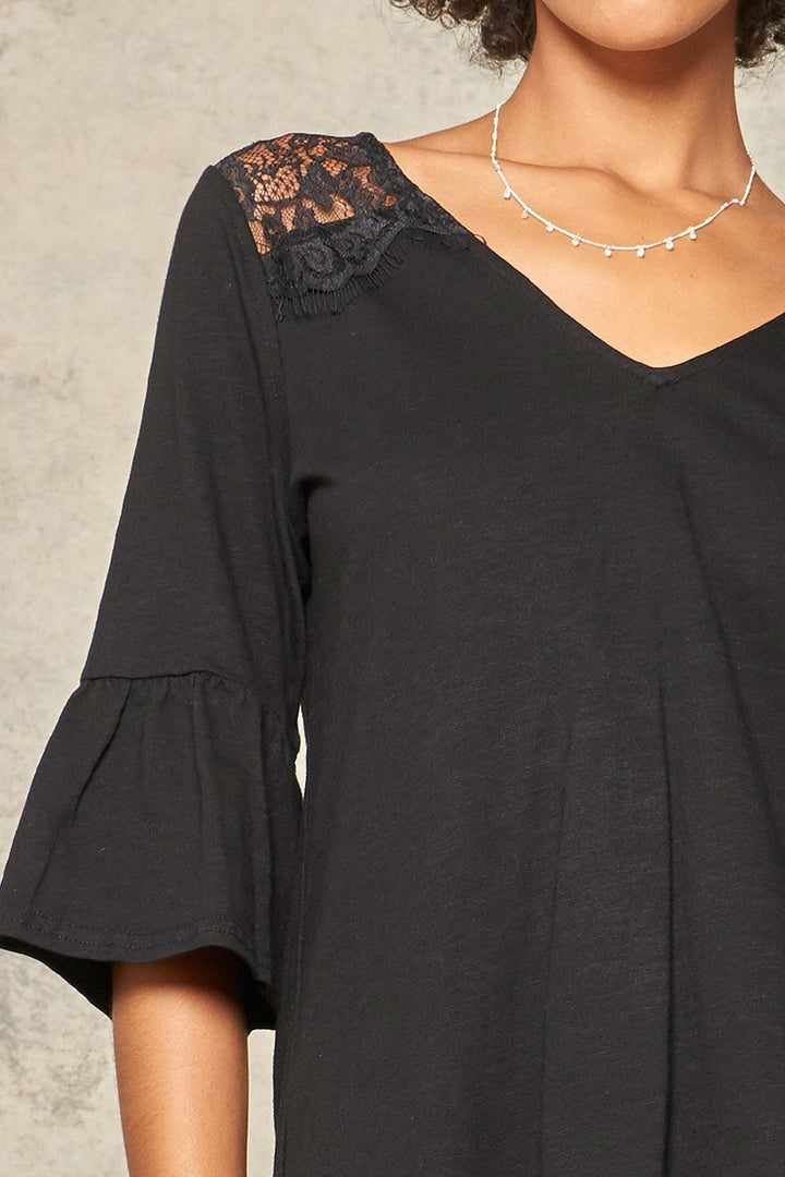 A Knit Top With Deep V Neckline And Yoke Design in Black