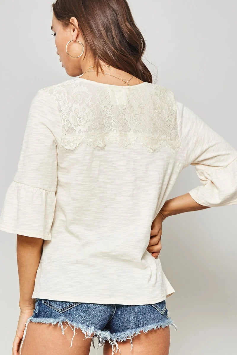 A Knit Top With Deep V Neckline And Yoke Design in Vanilla